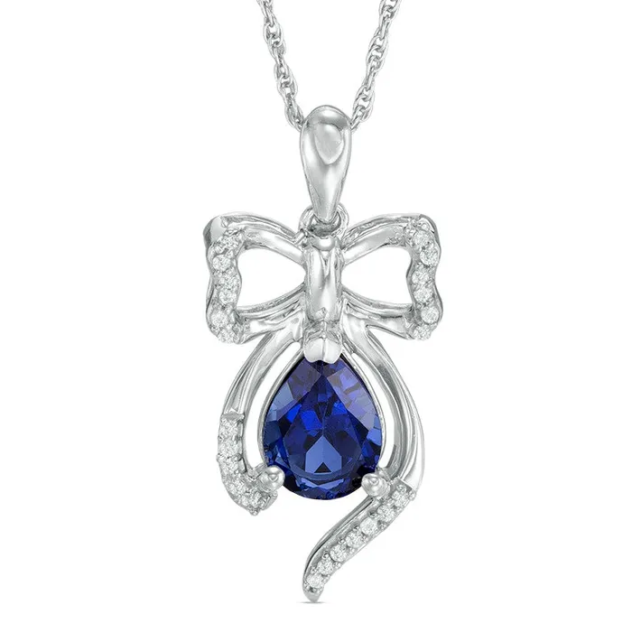 Goldia Necklaces PearShaped LabCreated Blue Sapphire and 01 CT TW Diamond Bow Pendant in Sterling Silver Goldia Necklaces PearShaped LabCreated Blue Sapphire and 01 CT TW Diamond Bow Pendant in Sterling Silver