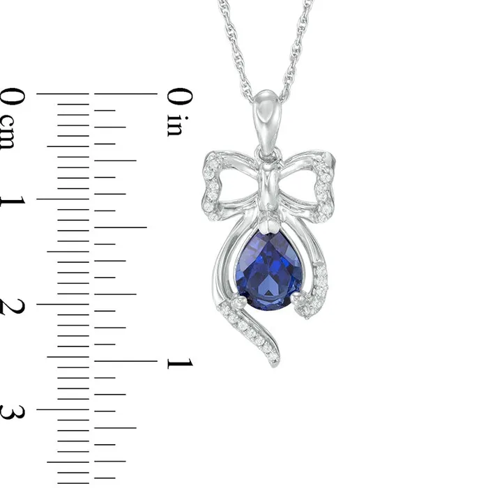 Goldia Necklaces PearShaped LabCreated Blue Sapphire and 01 CT TW Diamond Bow Pendant in Sterling Silver Goldia Necklaces PearShaped LabCreated Blue Sapphire and 01 CT TW Diamond Bow Pendant in Sterling Silver